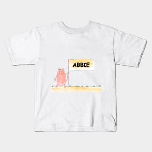 ABBIE name. Personalized gift for birthday your friend. Cat character holding a banner Kids T-Shirt